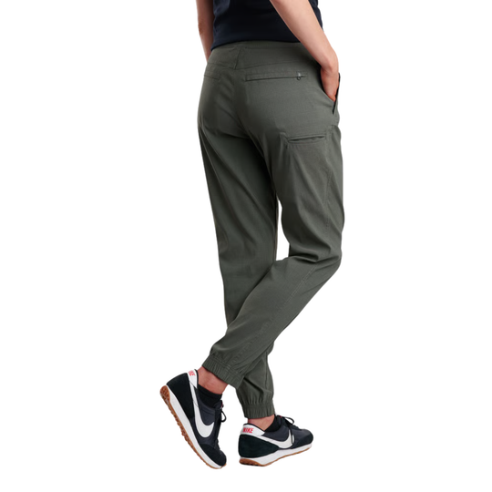 A person shown from the back wearing olive green tapered jogger pants with elastic cuffs and side pockets, paired with black and white Nike sneakers, on a solid white background.