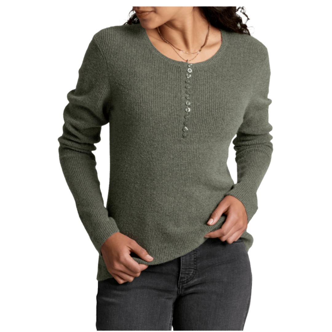 A woman wearing a ribbed knit long-sleeve sweater in a muted sage green color, featuring a buttoned henley neckline and dark gray jeans, shown against a plain white background.