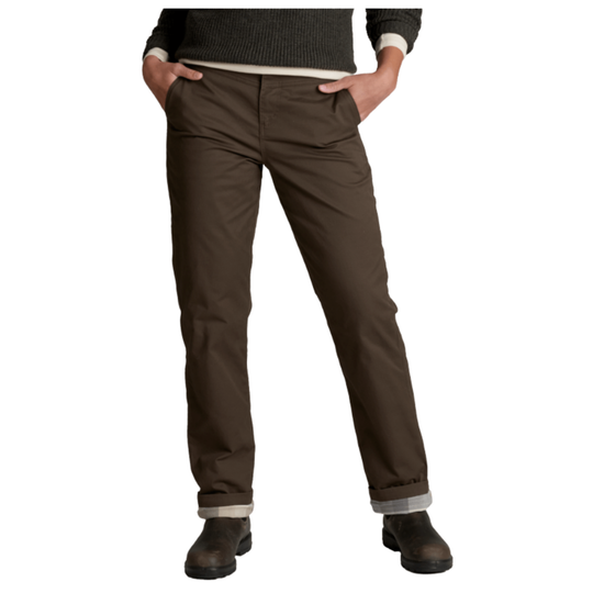 A person wearing dark brown straight-leg work pants with a ribbed knit sweater and dark boots, shown from the waist down on a white background.
