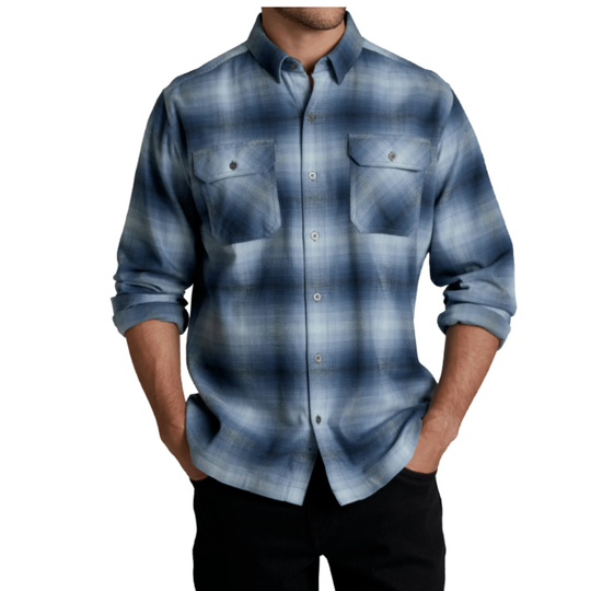 A man wearing a blue and gray plaid button-down shirt with rolled-up sleeves and black pants, shown from the chin down against a plain white background.