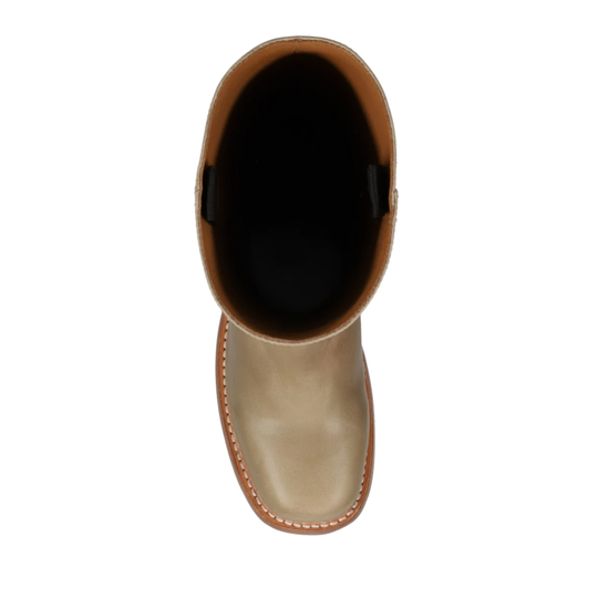 A top-down view of a light tan leather boot with a black interior lining, shown against a plain white background.