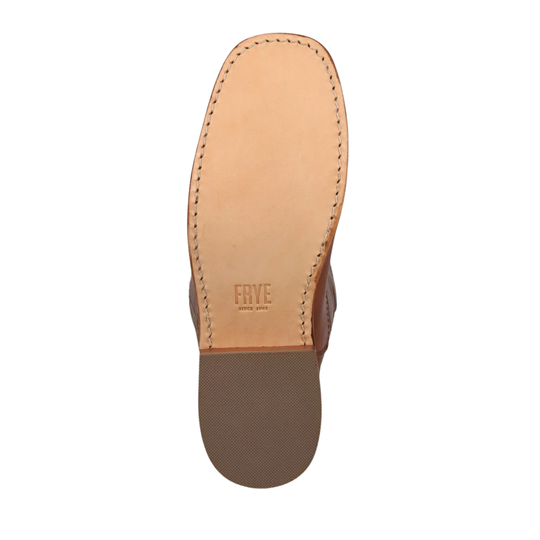 Top-down view of a single shoe sole, showing a light tan leather insole with visible stitching and the embossed brand name 'FRYE' on a white background.