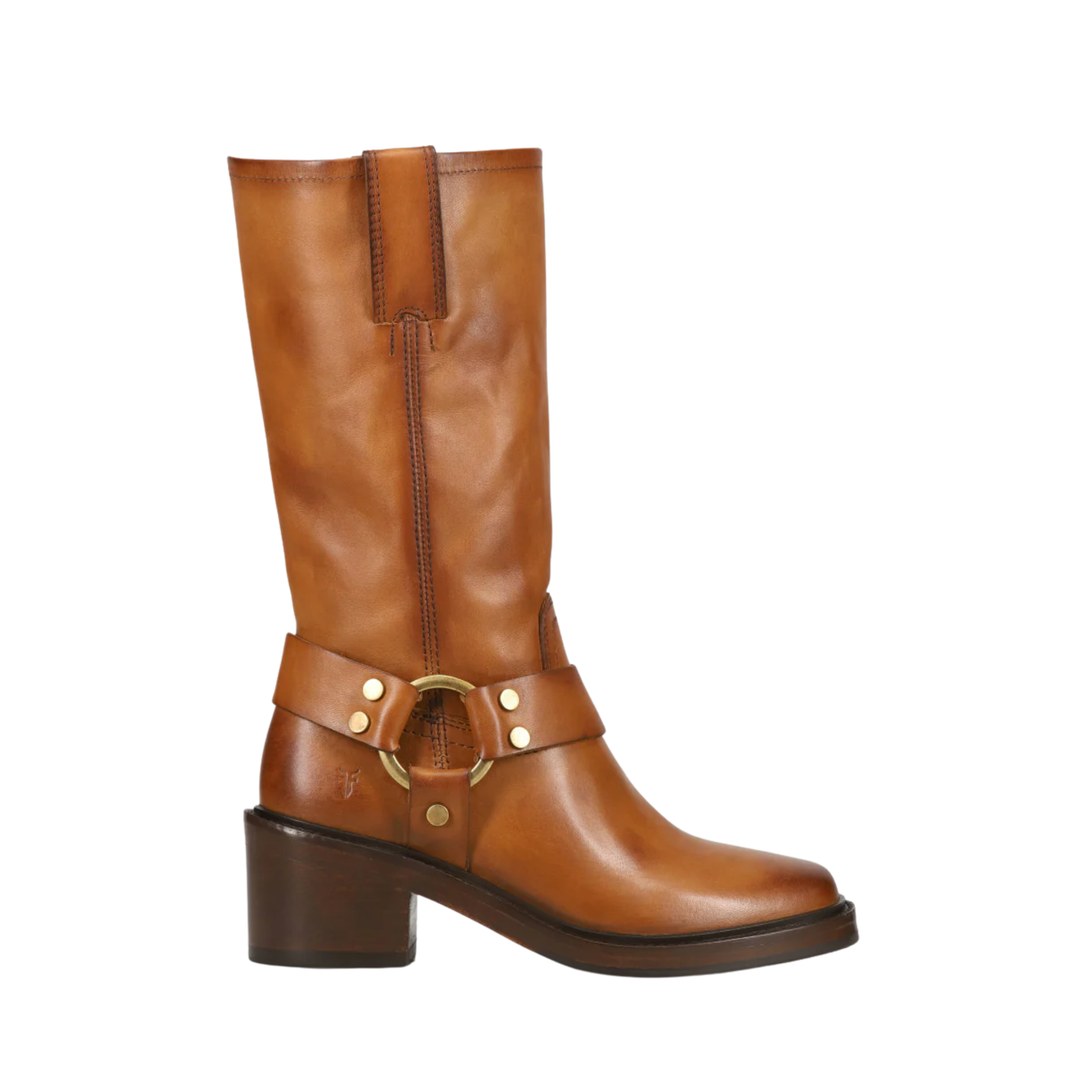 A mid-calf brown leather boot with a block heel, a decorative strap with brass-tone studs and a large ring detail around the ankle, and a pointed toe, shown against a plain white background.