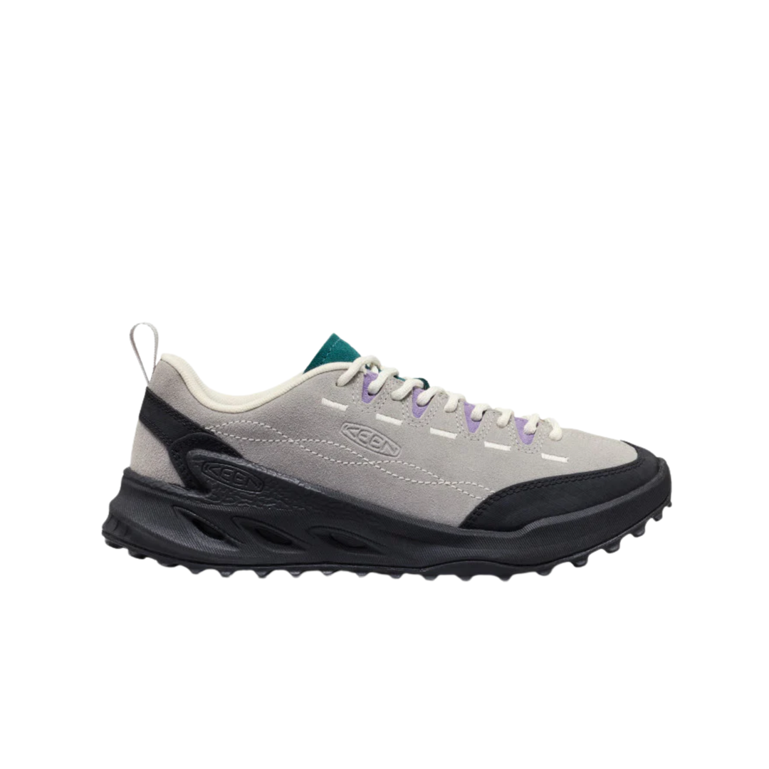 A light gray and black athletic sneaker with white laces, a small green tongue label, and subtle purple eyelet accents, shown from a side profile on a white background.