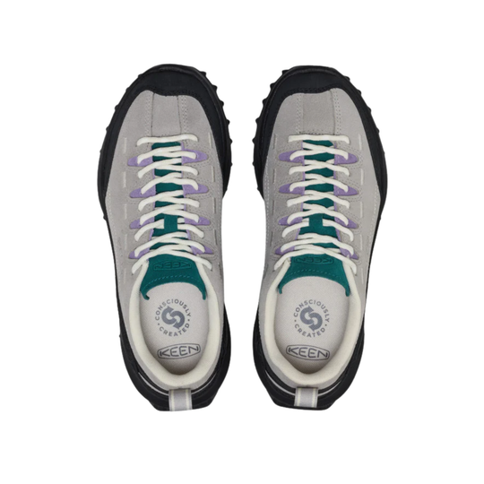 A pair of KEEN brand sneakers shown from a top-down view. The sneakers feature a light gray suede upper, white laces with purple tips, teal accents around the collar, and a black rugged outsole.