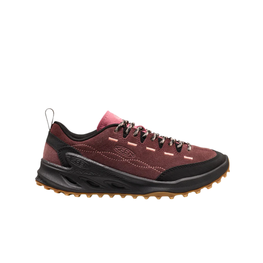 A single athletic shoe shown in profile against a plain white background. The upper is primarily a dusty burgundy red suede with black overlays, black laces, a pink tongue label, and a thick black midsole with a brown gum outsole.