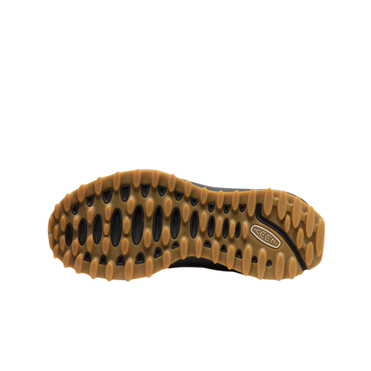 The outsole of a Keen shoe, showing a rugged tan and black tread pattern with the Keen logo on the heel.
