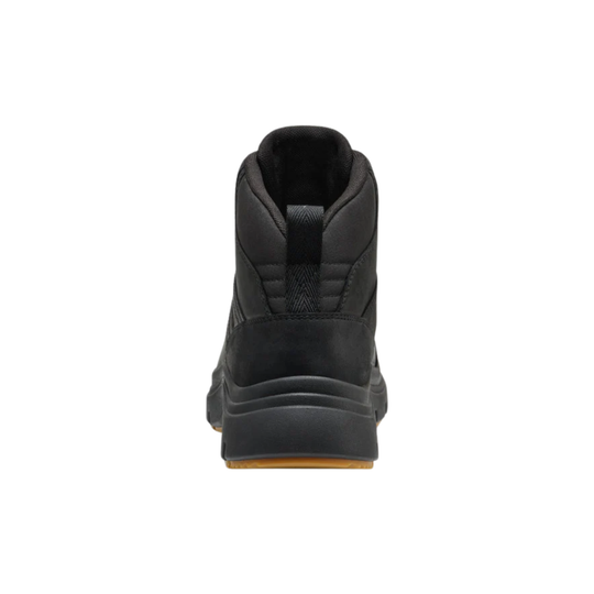 A black high-top boot shown from the back, featuring a thick black sole with a small brown gum outsole visible at the bottom, set against a plain white background.