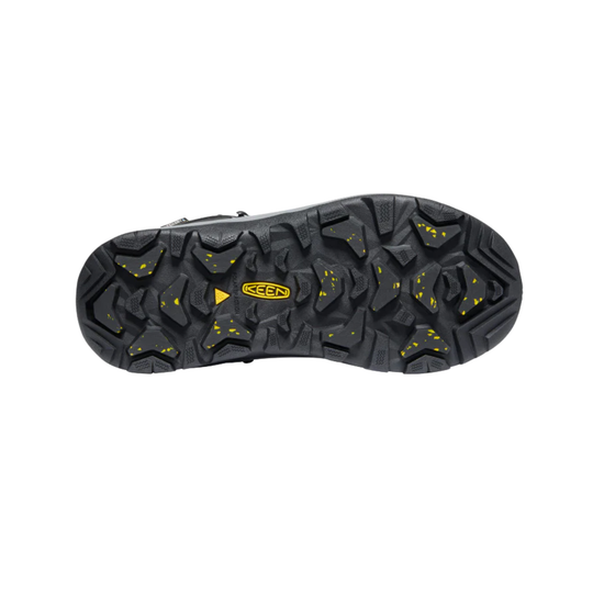 The black rubber outsole of a Keen hiking boot, featuring deep lugs and small yellow speckles and logo details, shown against a plain white background.