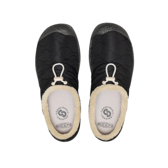 A pair of black Keen slip-on slippers with a cream sherpa lining and white drawstring loops, shown from a top-down view on a white background.