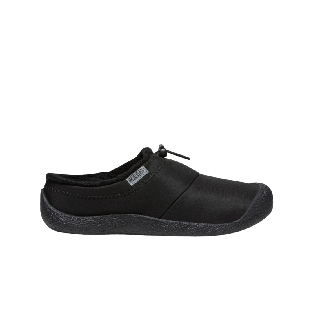 Black slip on shoe with black soles on a white background