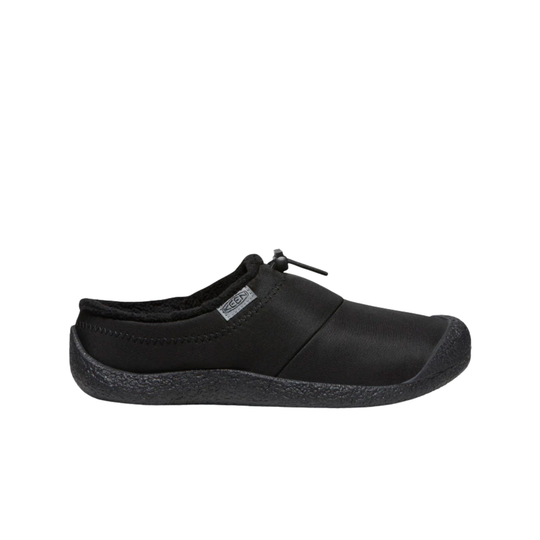 Black slip on shoe with black soles on a white background