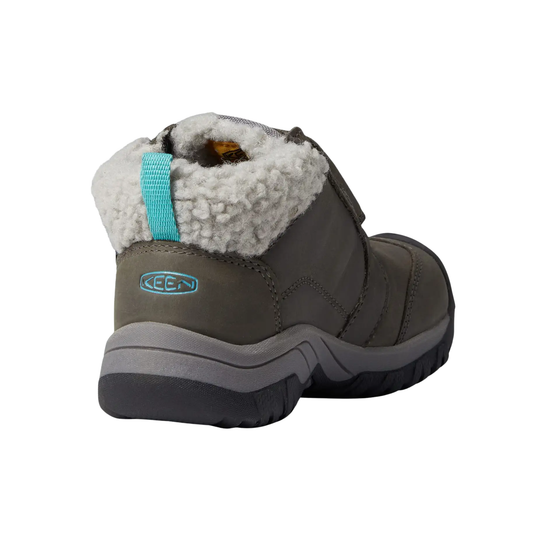 A single Keen mid-height winter boot in dark gray with a white sherpa lining and a bright turquoise pull tab, shown from a rear three-quarter angle on a white background.