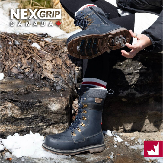 A person outdoors wearing a dark gray NexGrip Canada mid-calf work boot, with the other boot held up to show the tread. The scene includes snow, rocks, and a person's legs and hands.