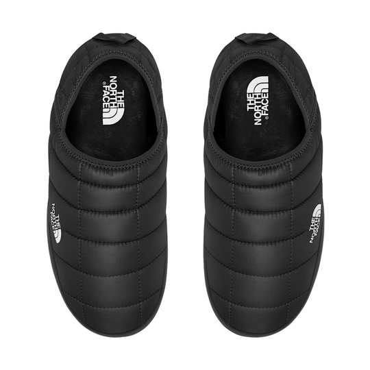 A pair of black quilted slip-on shoes by The North Face, shown from a top-down view on a solid white background.