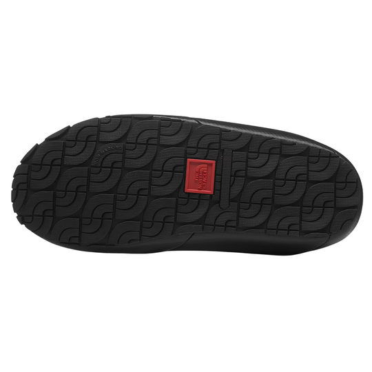 Bottom black sole with a red The North Face logo. On a plain white background.