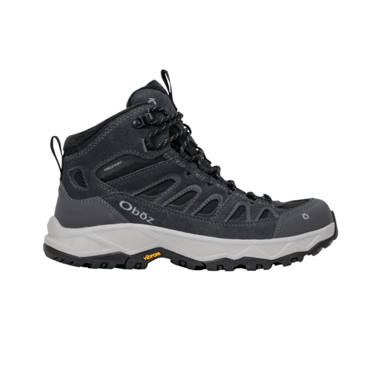 A dark gray and black Oboz mid-top hiking boot with a white midsole and Vibram outsole, shown from a side profile on a white background.