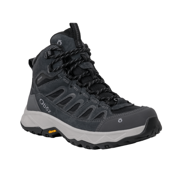 A dark gray and black mid-cut hiking boot with a white midsole and a small yellow Vibram logo on the outsole, shown against a plain white background.