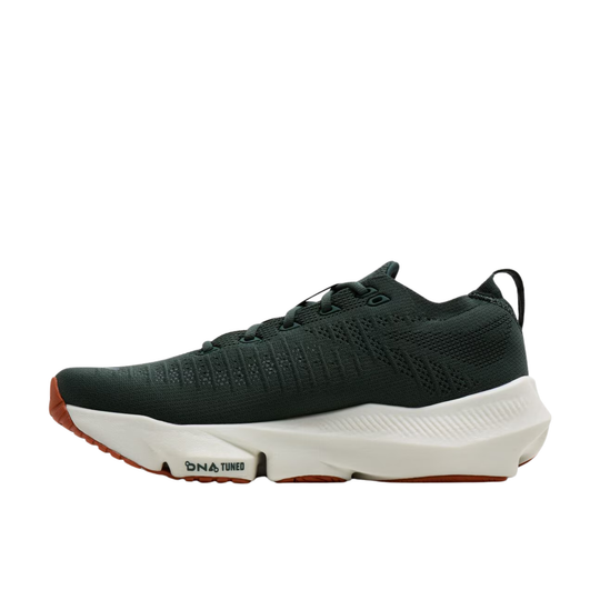 A dark forest green athletic sneaker with a thick white midsole and a small orange outsole accent, shown in a side profile on a white background.