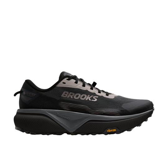 Black running shoe with yellow accents on a white background
