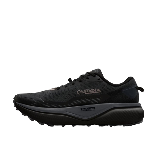 A black Cascadia trail running shoe with a thick black and gray midsole and a small rose gold logo on the side, shown against a plain white background.