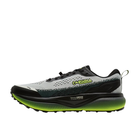 A trail running shoe from Cascadia, shown in a side profile view against a solid white background. The shoe features a light gray and black upper with a textured speckled pattern, a black midsole, and a vibrant neon yellow-green outsole and logo accent.