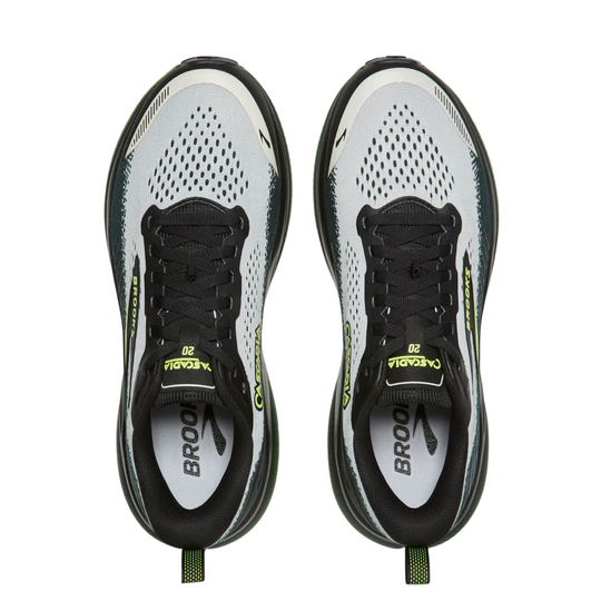 A pair of Brooks Glycerin running shoes shown from a top-down view, featuring a white and black mesh upper with neon yellow-green accents and the brand name 'BROOKS' printed on the insoles.