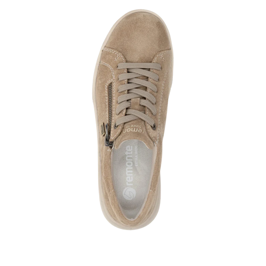 Beige sneaker with visible brand logo on a white background