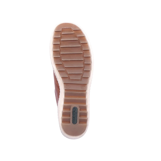 Close-up of a shoe sole with a brand logo on a white background