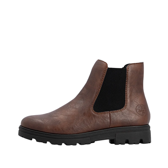 A brown leather Chelsea boot with a black elastic side panel and a chunky black lug sole, shown from a side profile on a white background.