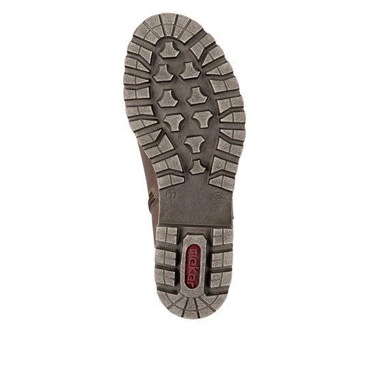 The outsole of a brown boot, showing a rugged tread pattern and a red 'rieker' brand logo on the heel, isolated on a white background.