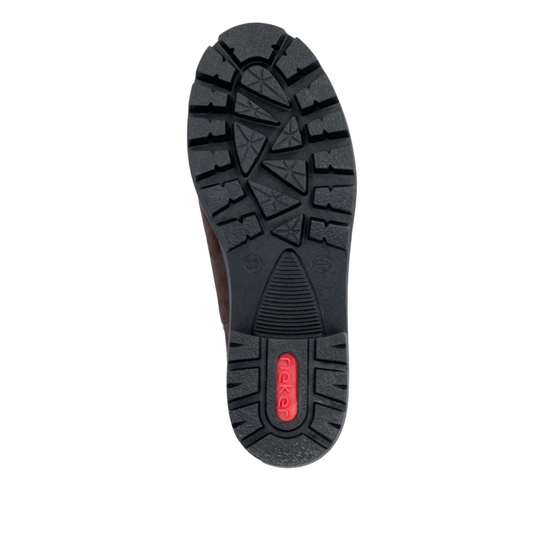 A top-down view of a black rubber shoe sole with deep tread patterns and a small red Flexfit logo on the heel, shown against a plain white background.
