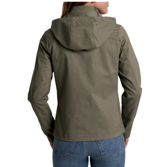 A woman viewed from the back wearing an gun metal  hooded jacket and blue jeans against a plain white studio background.