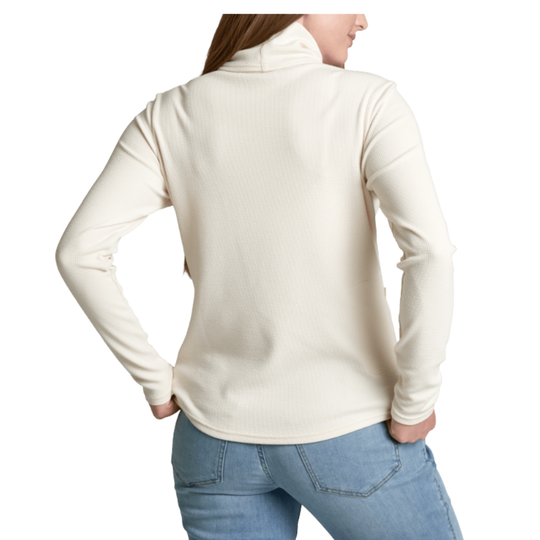 A woman shown from the back wearing a ribbed, long-sleeve cowl-neck top in cream, paired with light blue jeans, against a plain white background.