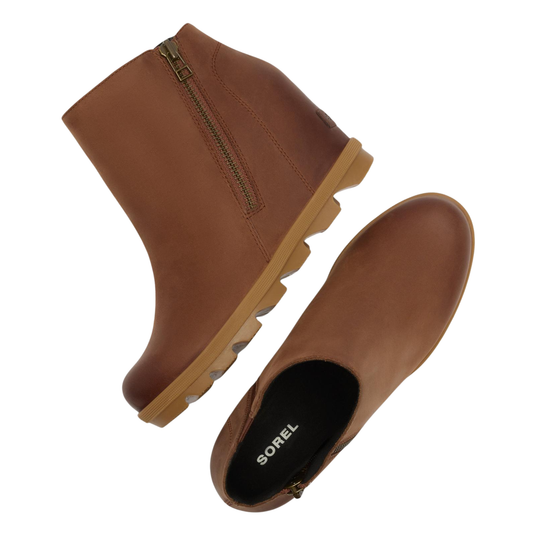 A pair of brown leather ankle boots with side zippers, shown from different angles on a plain white background. The brand name 'SOREL' is visible on the black interior footbed of one boot.