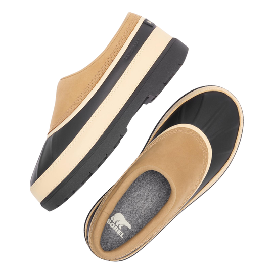 A pair of women's slip-on clogs shown from multiple angles on a white background. The shoes feature a tan suede-like upper, a thick black and cream midsole stripe, a black rubber outsole, and a gray textured interior footbed with the 'sorel' brand name and bear logo visible.