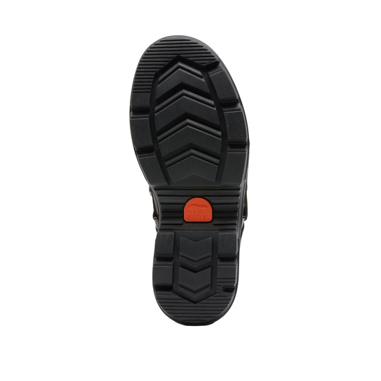 The black rubber outsole of a shoe, showing a textured chevron tread pattern and a small orange accent tab near the heel, isolated on a white background.