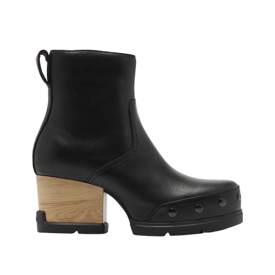 A black leather ankle boot with a chunky block heel made of natural wood, featuring a low black platform sole with metal studs on the toe, shown against a plain white background.