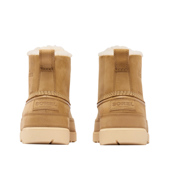A pair of tan suede ankle boots with white shearling lining, shown from the back on a solid white background. The brand name 'SOREL' is embossed on the heel strap.