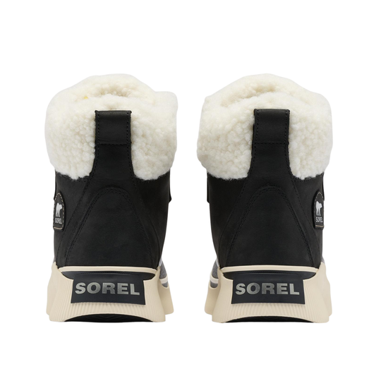 A pair of Sorel mid winter boots shown from the back, featuring a black suede upper, thick white shearling lining, and a cream-colored sole with the SOREL brand name.