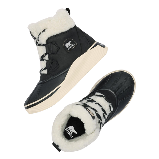 A pair of black mid-calf winter boots with thick white shearling lining and black-and-white patterned laces, shown on a solid white background.