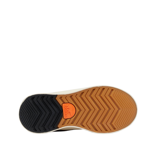 Top-down view of a shoe sole showing a black treaded heel, a tan zigzag-patterned midsole, and an orange circular logo patch in the center.