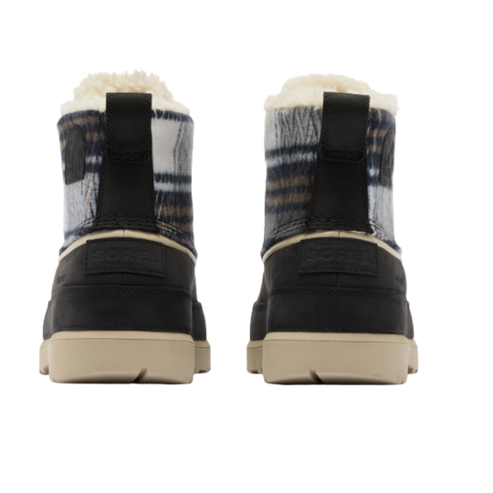 A pair of Sorel mid-calf winter boots shown from the back, featuring a black and navy plaid patterned upper with a cream shearling lining and beige soles.