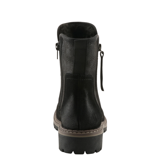 A black leather ankle boot shown from the back, featuring a side zipper, a pull tab, and a chunky lug sole.