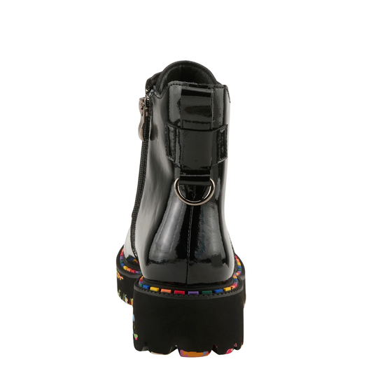 A black patent leather ankle boot shown from the back, featuring a side zipper, a decorative strap with a metal D-ring, and a chunky sole with colorful embroidered details.