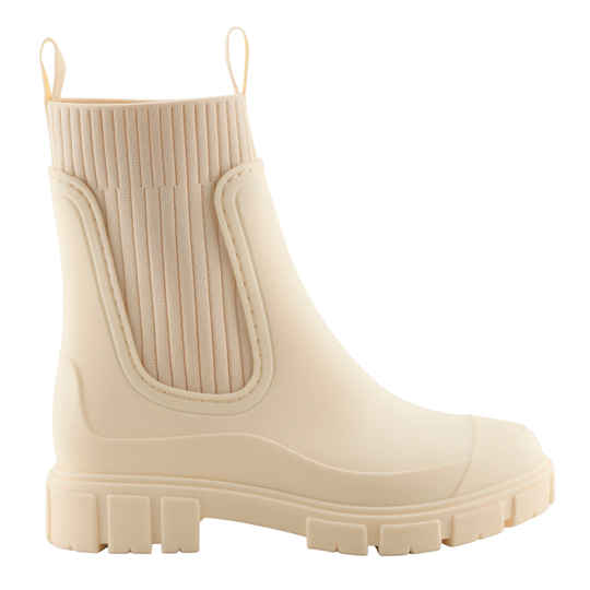 A single low-top rubber rain boot in a solid cream color, featuring a ribbed elastic side panel and pull tabs at the collar, shown against a plain white background.