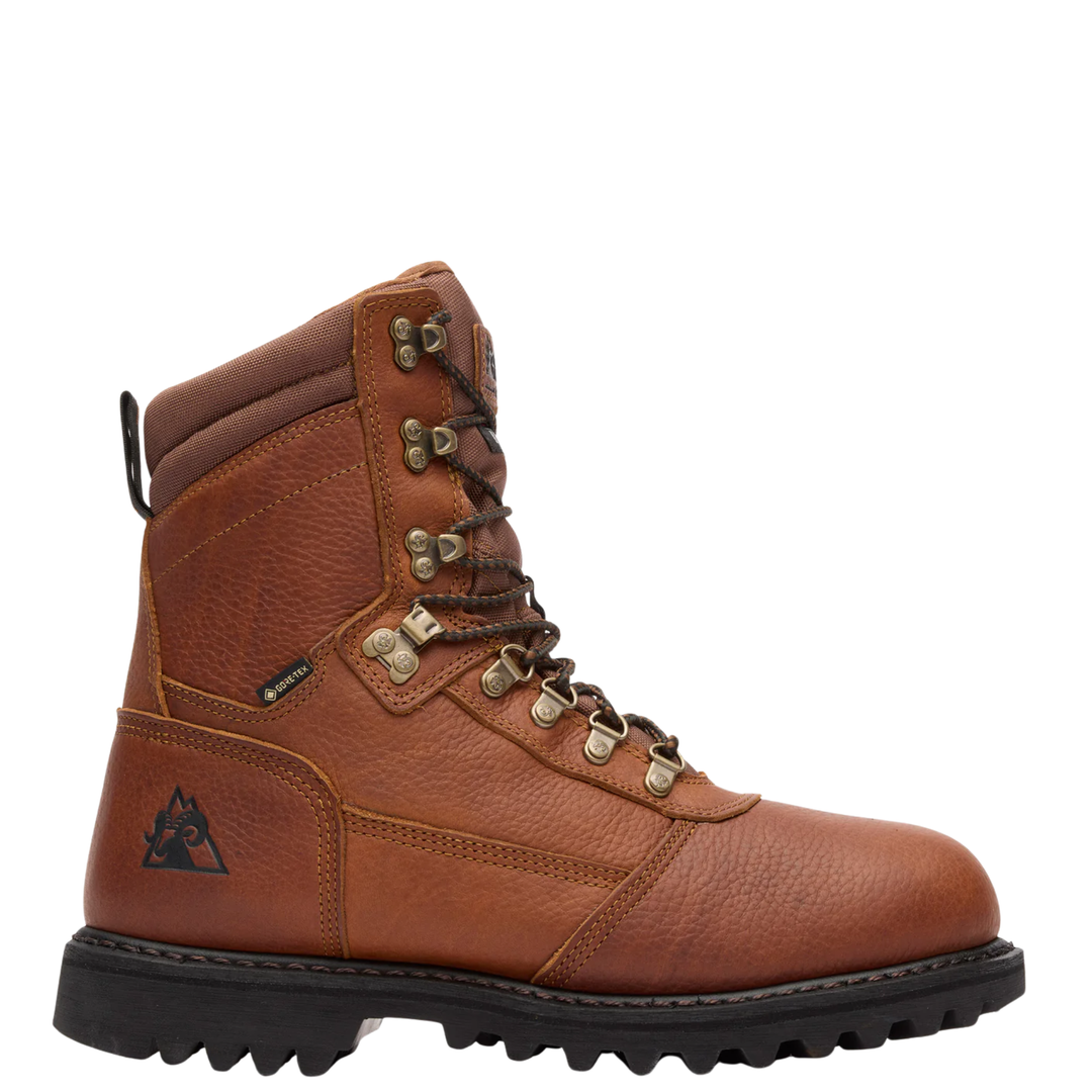 A brown leather ankle hiking boot with a black sole, brown laces, and brass-colored metal eyelets, shown from a side profile on a white background.