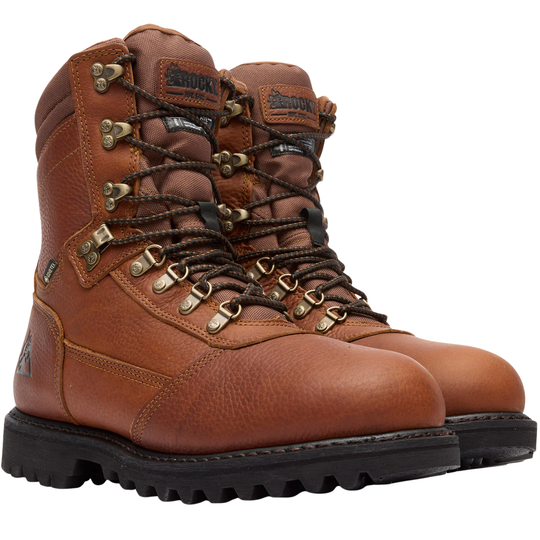 A pair of brown leather high-top work boots with black laces, brass eyelets, and black soles, shown on a plain white background.