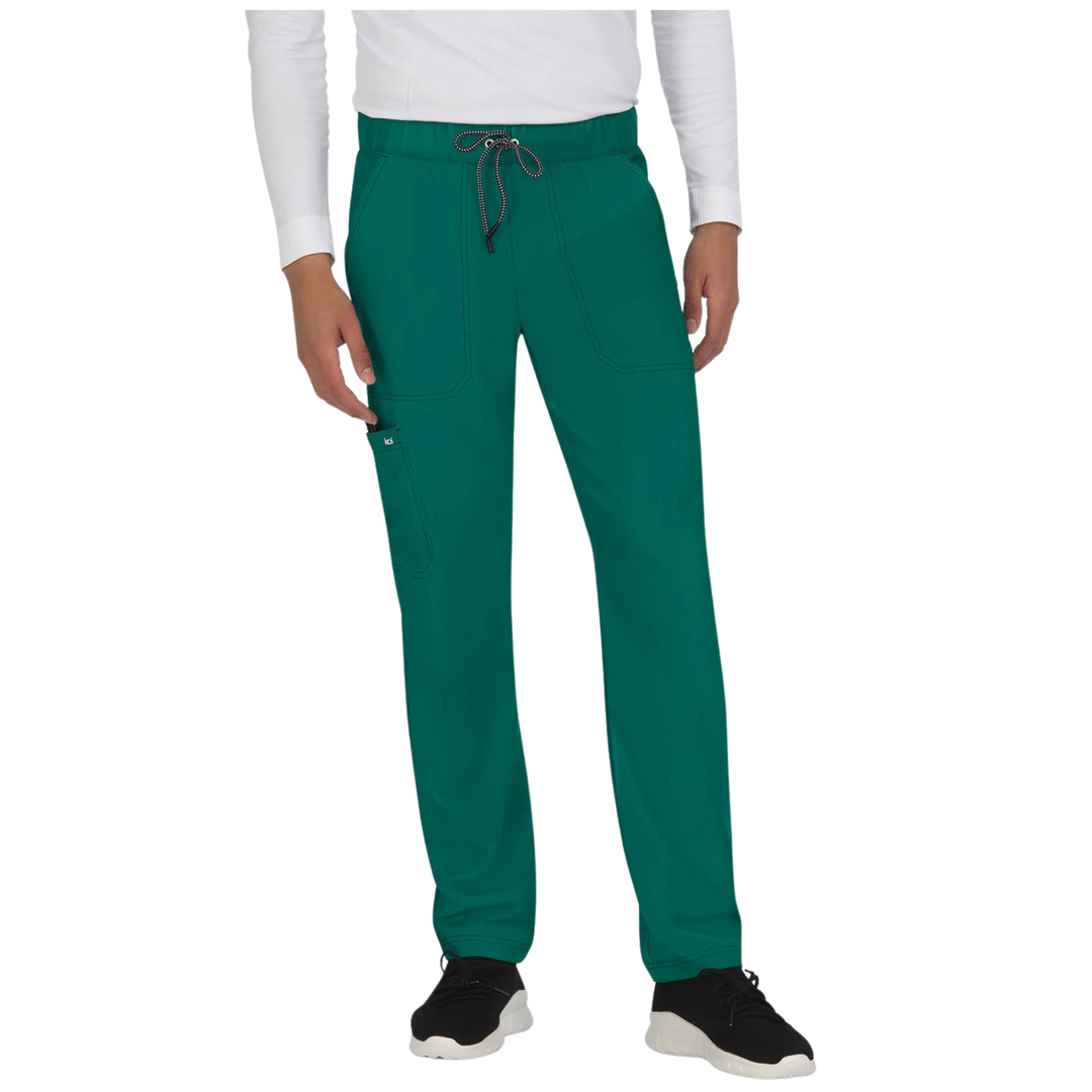 A person wearing teal scrub pants with a drawstring waist, shown from the chest down against a plain white studio background.
