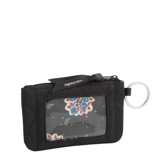 A black quilted card holder wallet with a clear ID window showing a colorful mandala print, a black zipper tab with 'Vera Bradley' text, and a silver keyring on a white background.